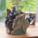 Dark gray cat planter holder figure on tree-stump base