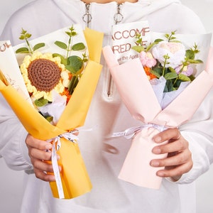 Crochet sunflower and rose bouquet with yellow blooms, wrapped with ribbon and paper