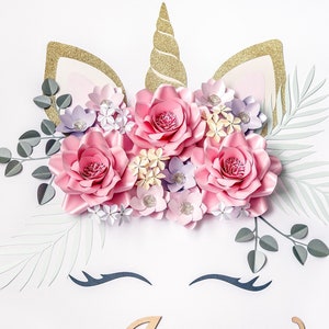 Unicorn wall sticker with pastel paper flowers and gold horn, closed-eye face