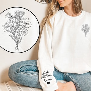White sweatshirt with bouquet line-art graphic on chest and personalized name text on sleeve