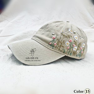 Tan baseball cap with hand-embroidered wildflowers and bee patch
