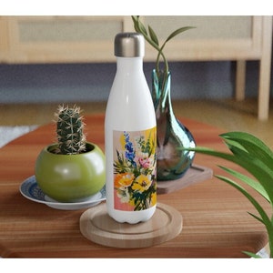 White stainless steel water bottle with floral bouquet wrap and metal screw cap