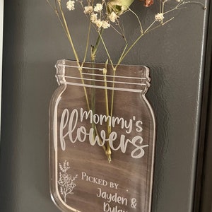 Glass mason-jar flower holder with etched Mommy's Flowers text and bouquet stems