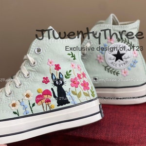 Black high-top sneakers with cat and flower embroidery, lace-up design