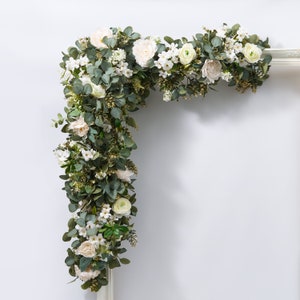 Faux white wedding eucalyptus garland with white blooms and green leaves