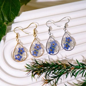 Forget-me-not flower resin drop earrings with blue floral teardrop pendants and metal hooks