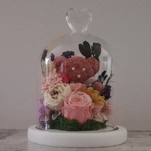 Handmade brown teddy bear with preserved roses and dried flowers under clear dome