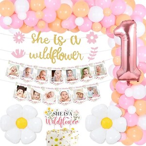 1st birthday party kit with pink balloons, banner reading 'She is a wildflower'