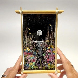 Moon phase pressed flower wall frame, black background, gold trim, crescent moon and florals
