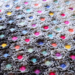 Crochet throw blanket with multicolor bobble flower motifs