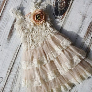 Beige lace flower girl dress with tiered ruffles and floral applique
