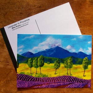 Lavender landscape postcard with purple field, green trees, and blue mountains sky