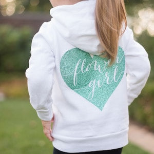 White hoodie with mint green heart graphic on the back