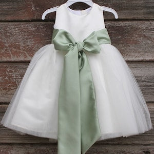Ivory tulle flower girl dress with sage satin bow sash and lace bodice