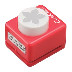 Red paper punch with white top, compact crafting tool for cutting flower shapes