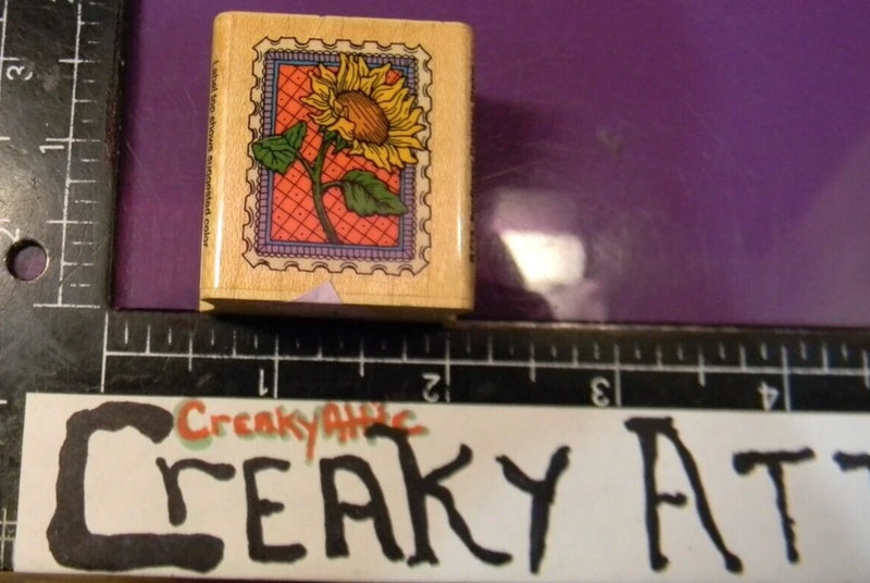 Small sunflower flower postage rubber stamp on wooden block