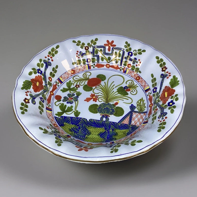 Blue and white ceramic serving bowl with multicolor floral and coastal scene