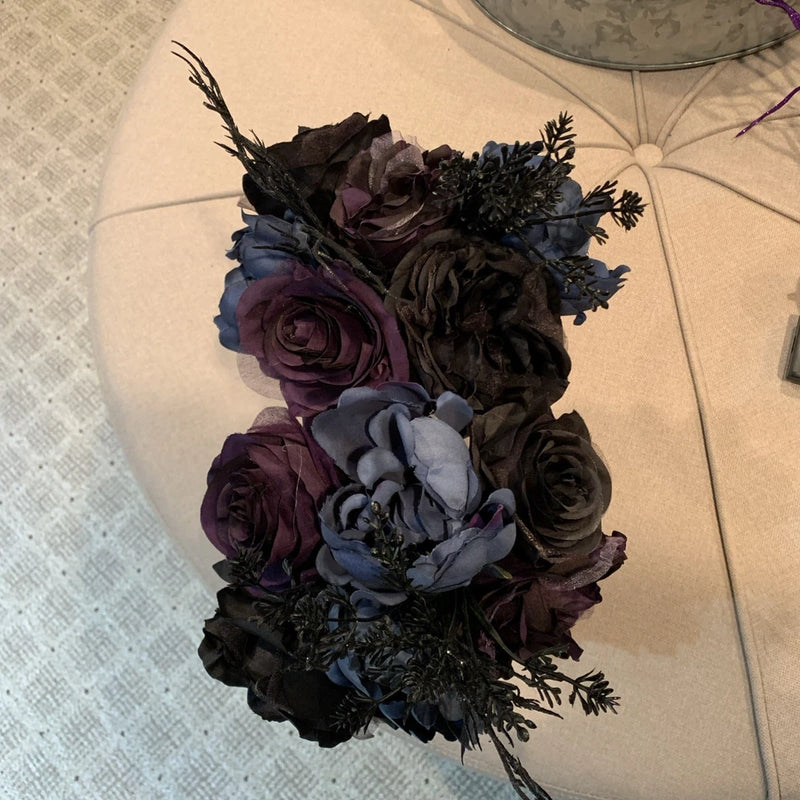 Dark floral bouquet with purple, blue, and black roses and peony-style blooms