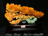 Glossy amber-gold carved peony Ru Yi sculpture with detailed blossoms and base