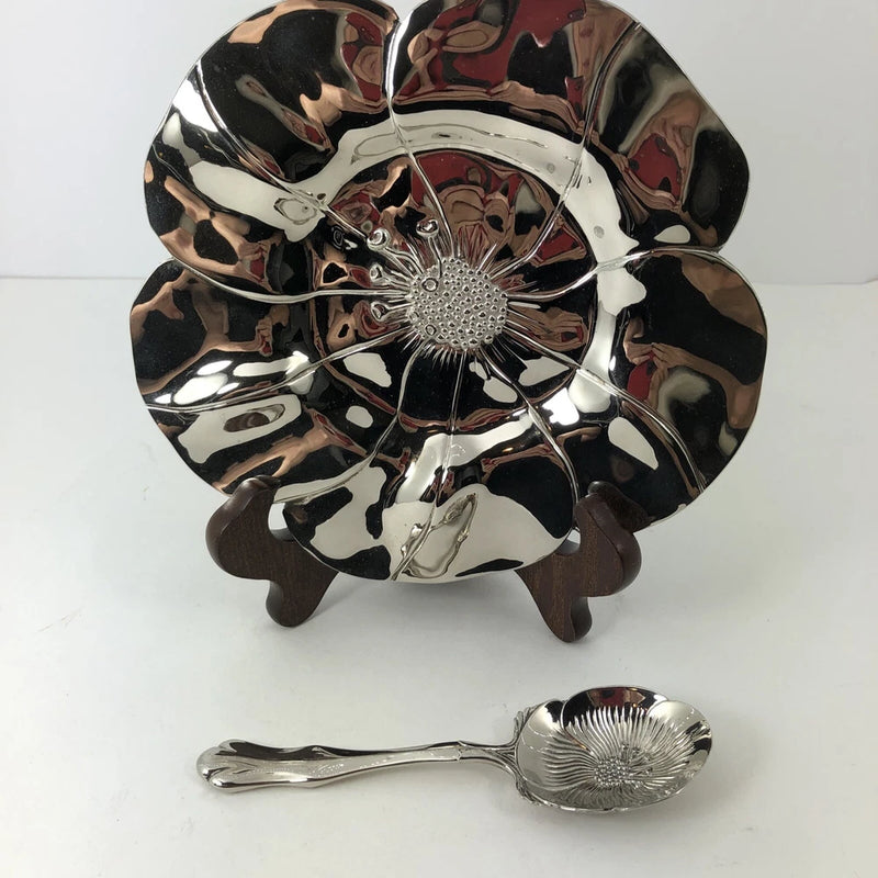 Sunflower-shaped silver-tone serving plate and matching spoon, reflective flower design
