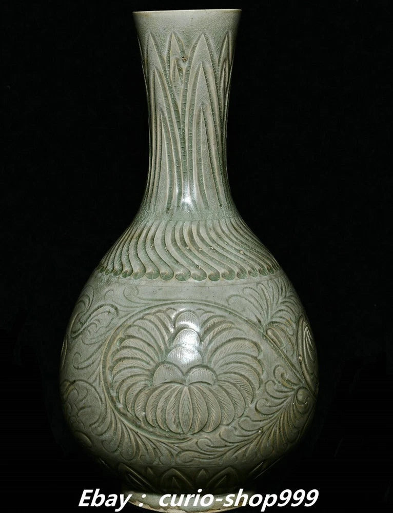 Tall celadon porcelain bottle vase with carved peony floral relief, rounded body, narrow neck