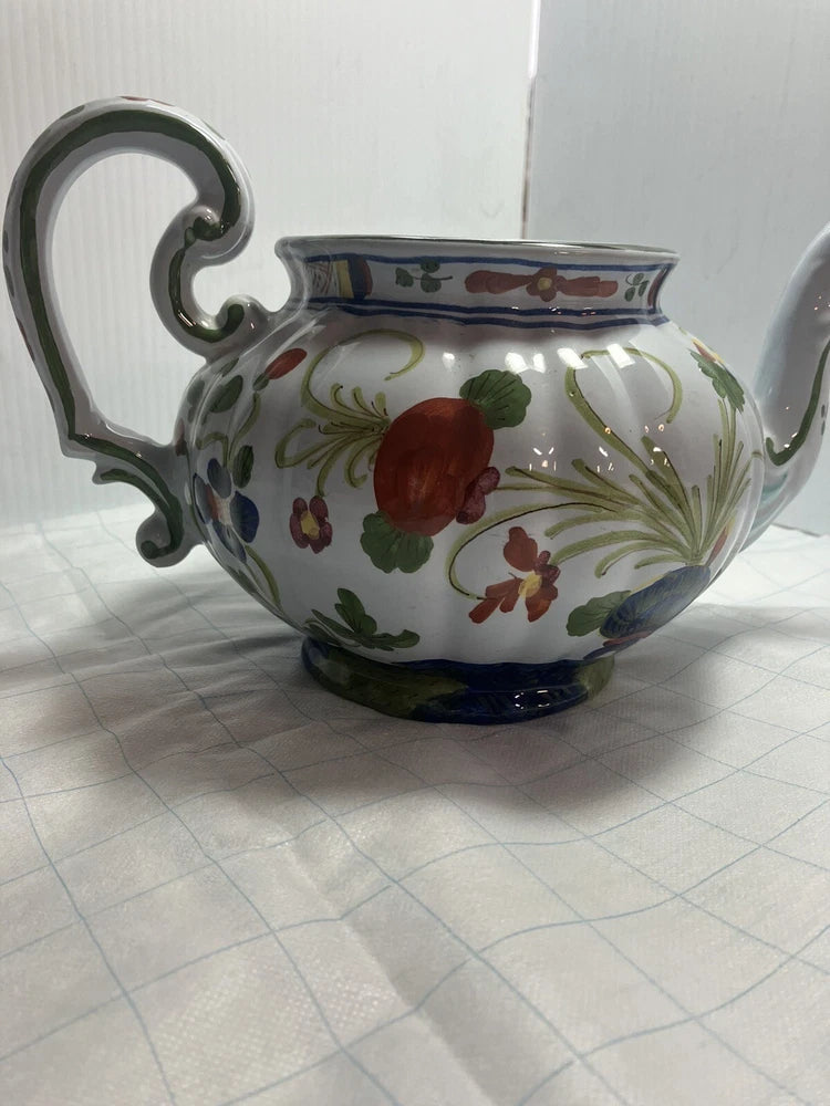 Blue floral ceramic teapot with curved handle and spout