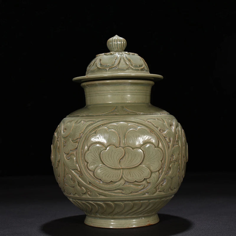 Cyan glazed porcelain lidded jar with raised peony flower medallion on body