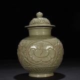 Cyan glazed porcelain lidded jar with raised peony flower medallion on body