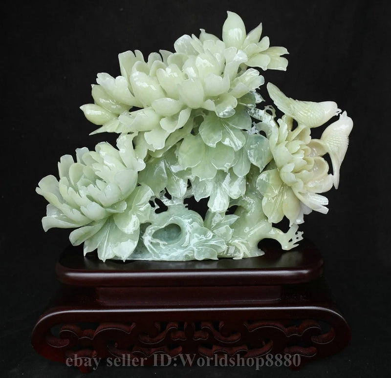 Carved green jade peony flower and bird sculpture on wooden stand