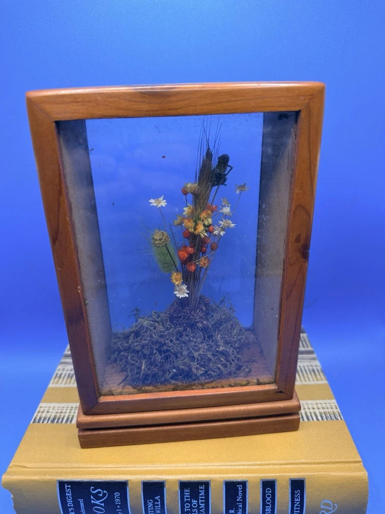 Wooden vintage display case with glass front, filled with dried flowers and foliage