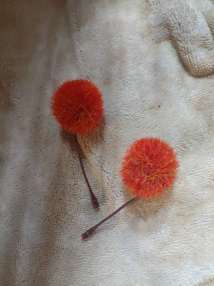 Artificial red lily flowers, two fuzzy blooms on stems