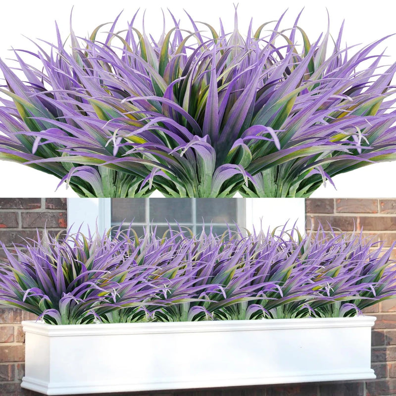 Artificial grass faux plants with purple and green spiky blades in white rectangular planter