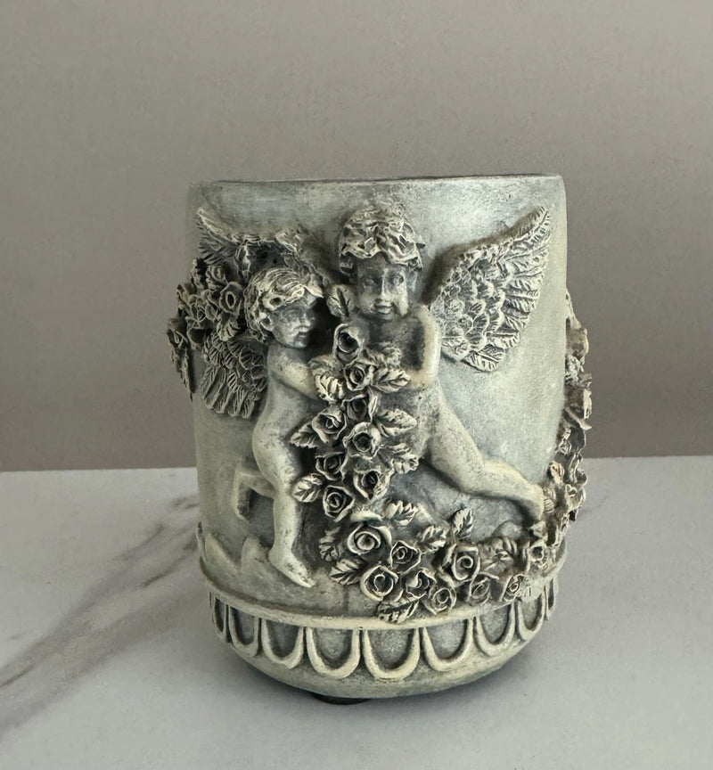 Vintage angel planter vase with ornate cupid relief and rose accents, metal-look finish