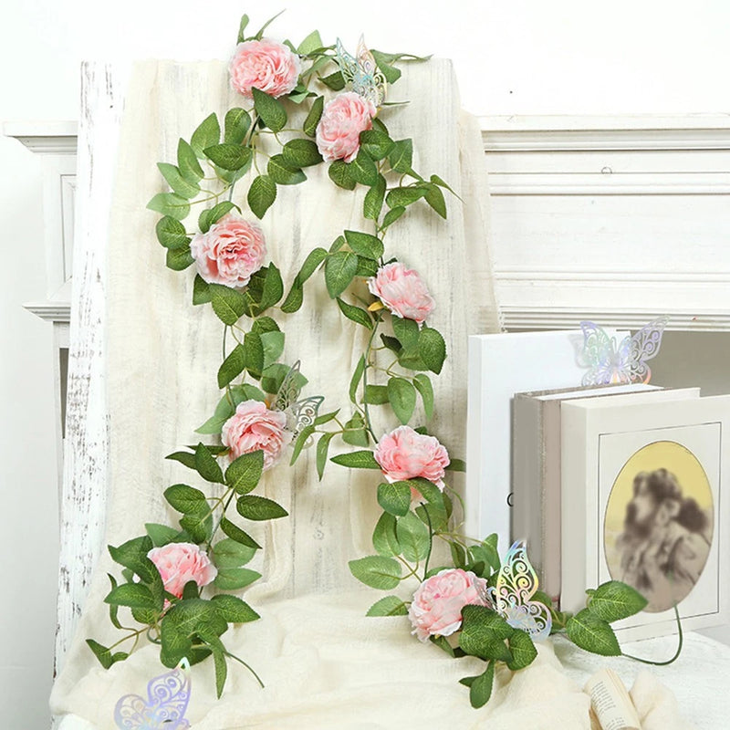 Cream wall hanging with pink faux roses and peony blooms on green vine leaves