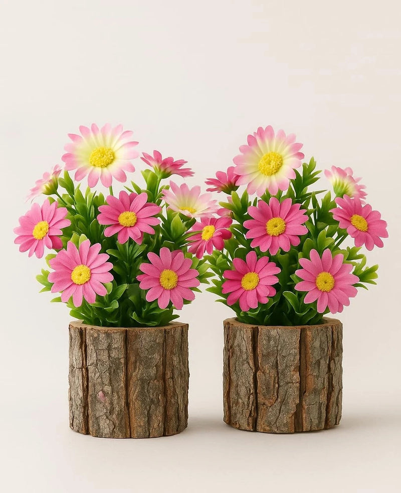 Set of 2 artificial pink daisies with yellow centers in rustic wood log planters