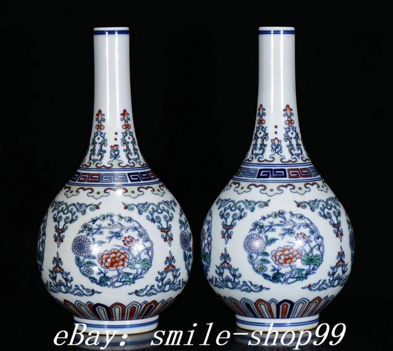 Pair of white porcelain bottle vases with blue and red peony floral designs