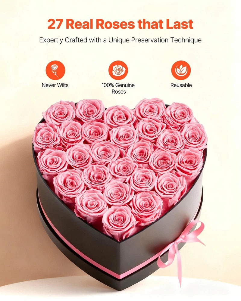Heart-shaped box of preserved pink roses with ribbon bow