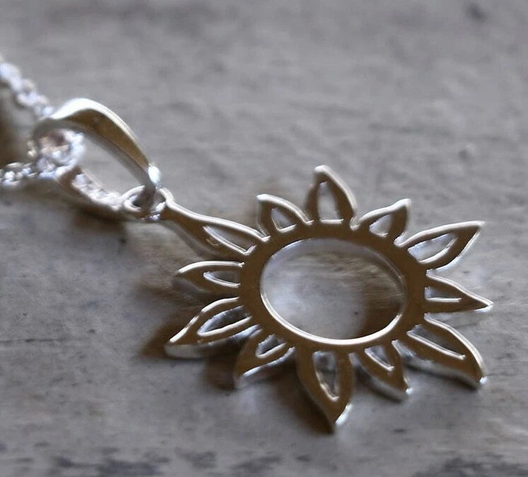 Silver-tone sunflower charm pendant with openwork petals and loop bail