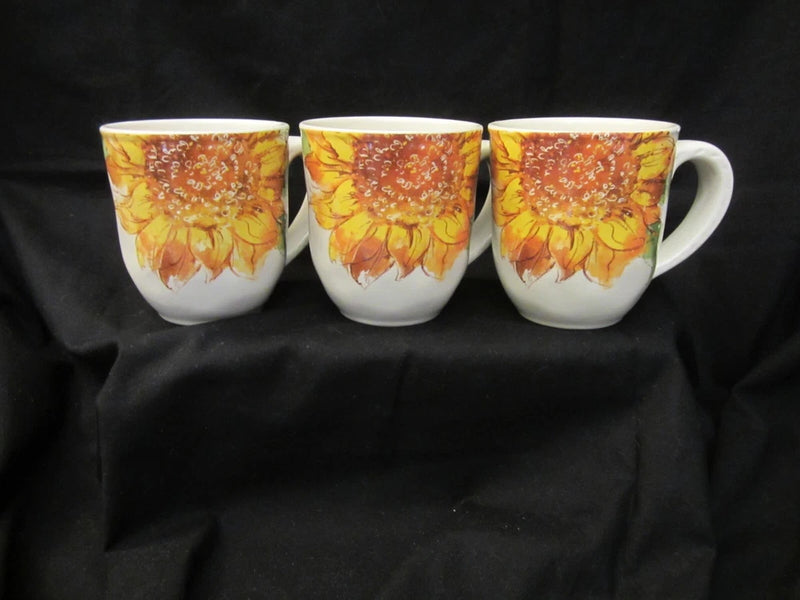 Set of three sunflower mugs with yellow and orange bloom prints and white handles