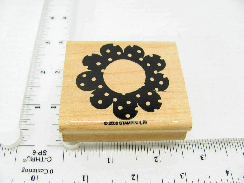 Sunflower rubber stamp with black flower design on a light wood block