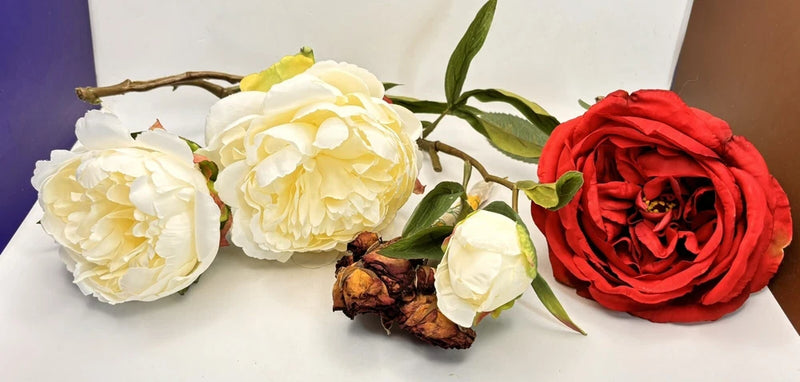 Artificial silk flower bouquet with white and red peony-style blooms and green leaves