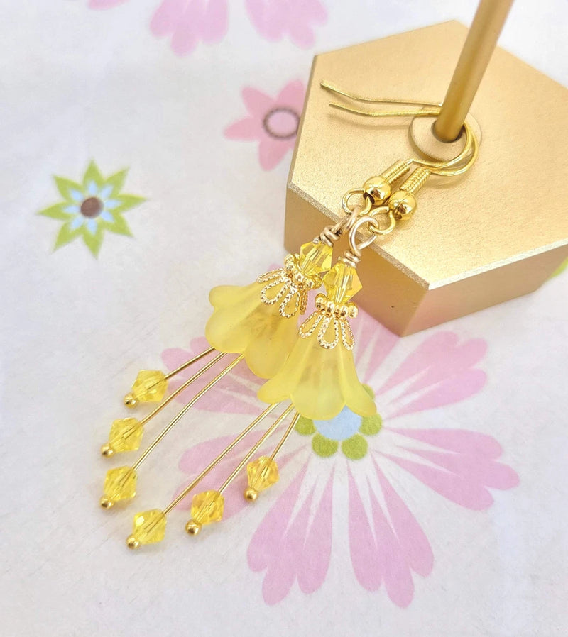 Bell flower earrings with yellow floral bells and gold-tone bead tassel drops