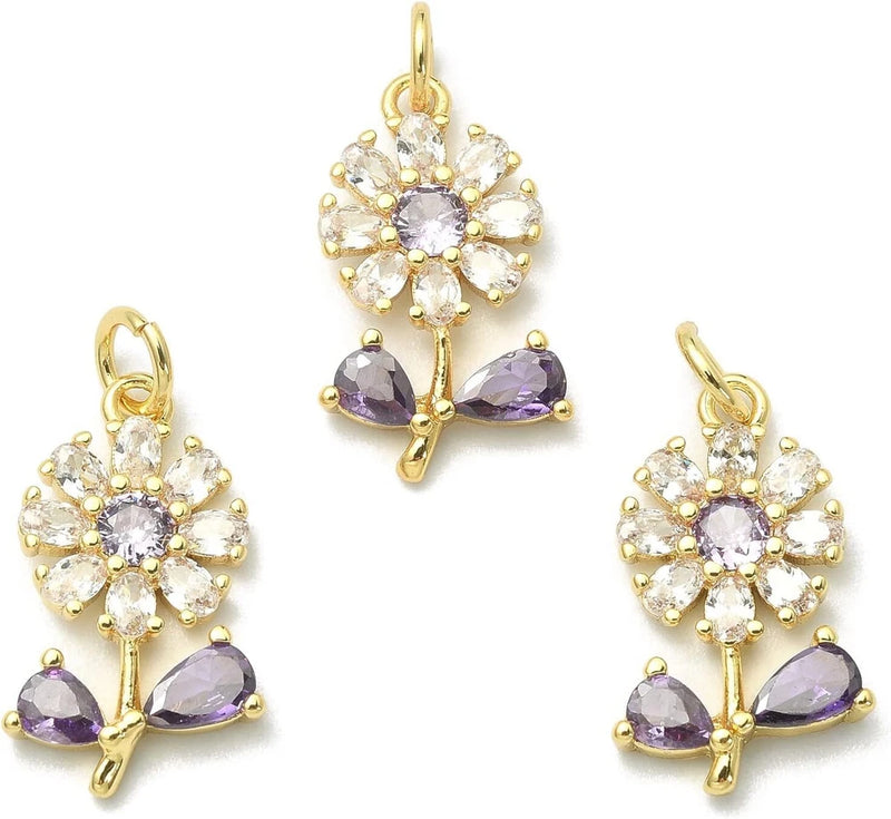 Gold-tone rhinestone sunflower charms with clear stones and purple crystal accents, hanging loops