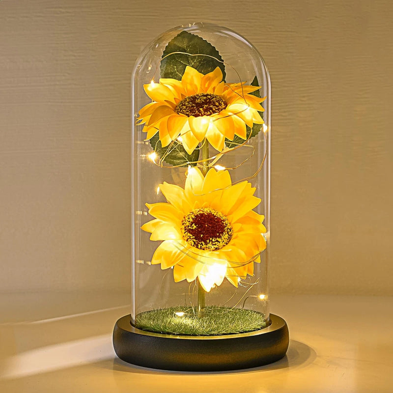 Artificial sunflower flowers in clear glass dome with LED lights and round base