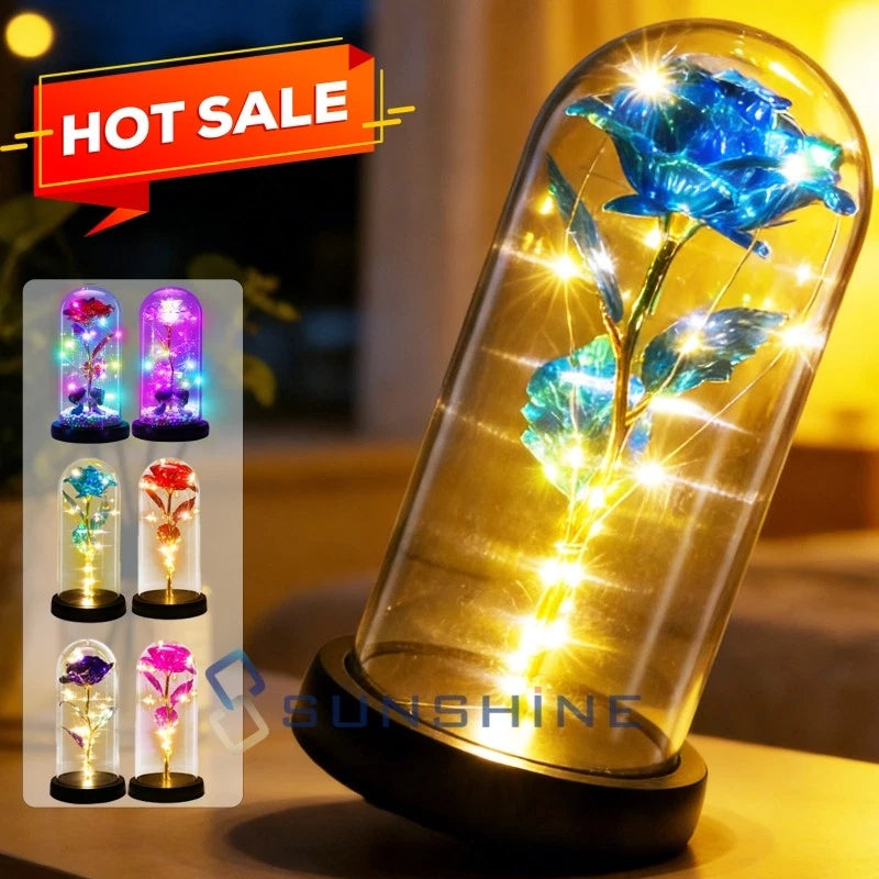 LED light-up rose in clear glass dome with glowing blue petals, on black base