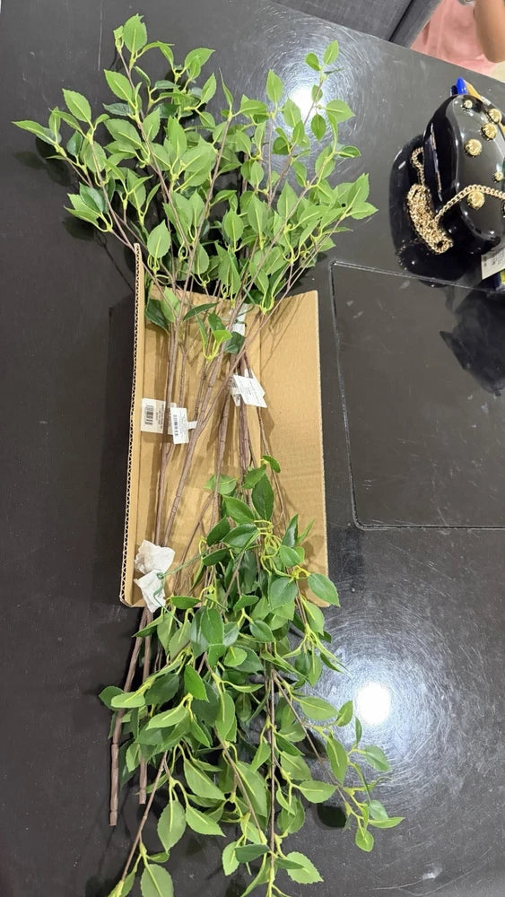 Artificial green plastic plant stems with layered leaves, decorative bundle