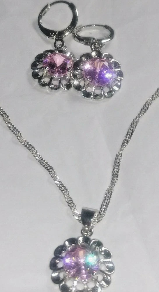 Silver flower pendant necklace with purple crystal center and matching drop earrings