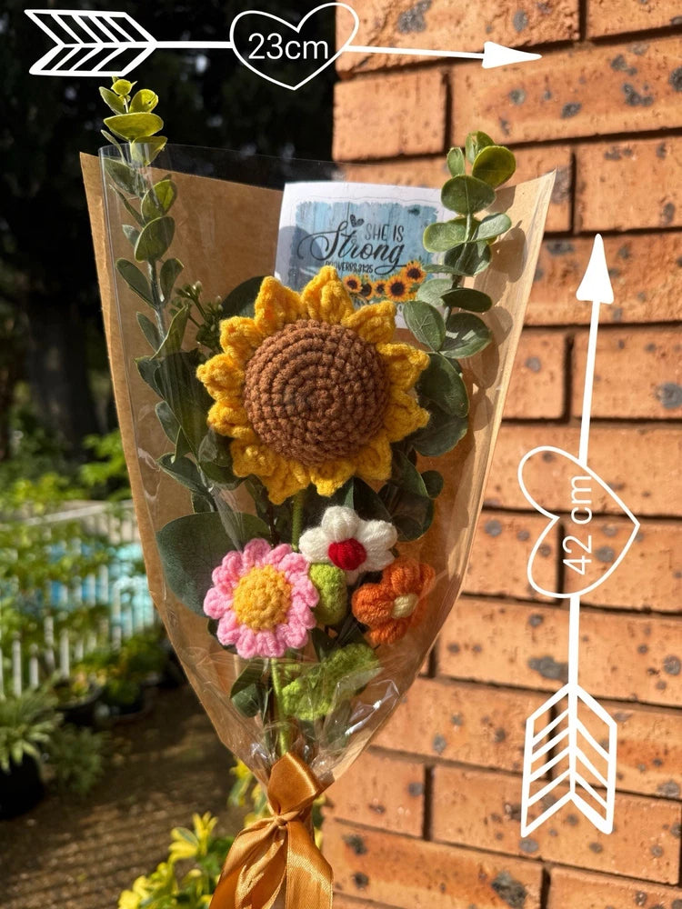 Handmade crochet flower bouquet with sunflower and small pink blooms, wrapped in a triangular bag