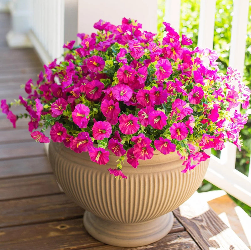 Artificial potted flower plant with bright pink and magenta blooms and green leaves