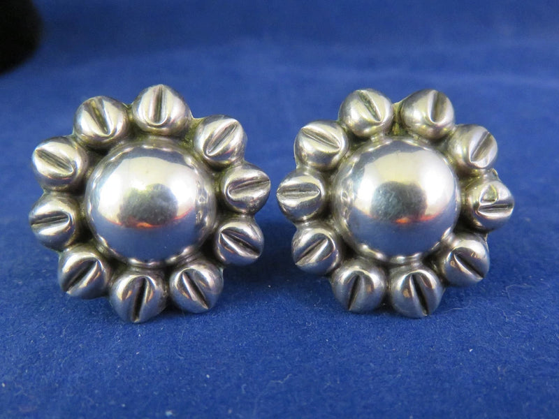 Silver sunflower stud earrings with raised petals and screw-back closures